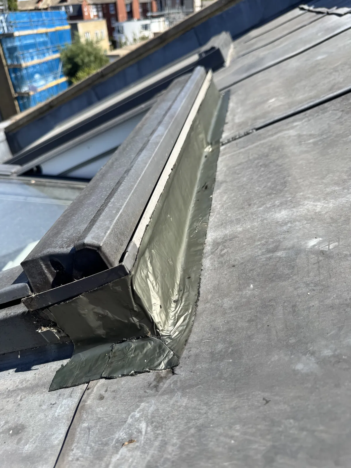 Lead flashing and gutter detail at the edge of a London roof