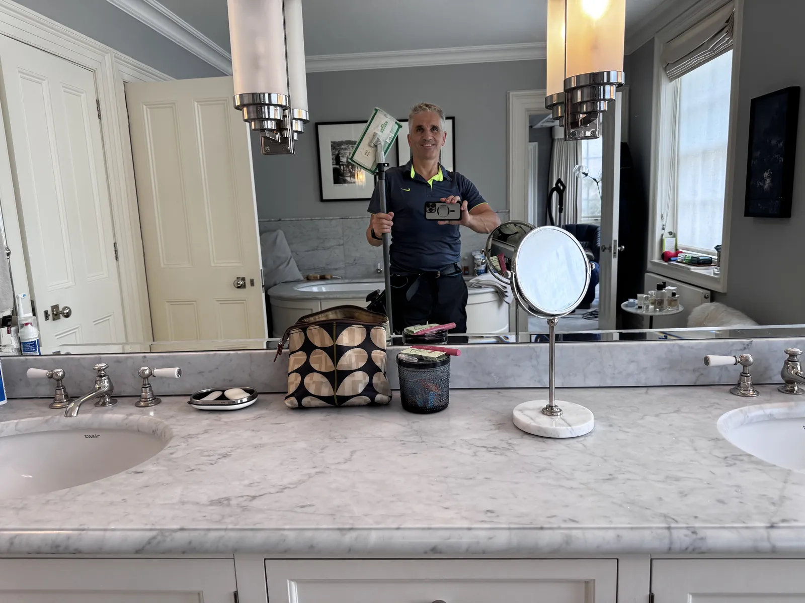 Marble bathroom surfaces and mirror cleaned in a London home