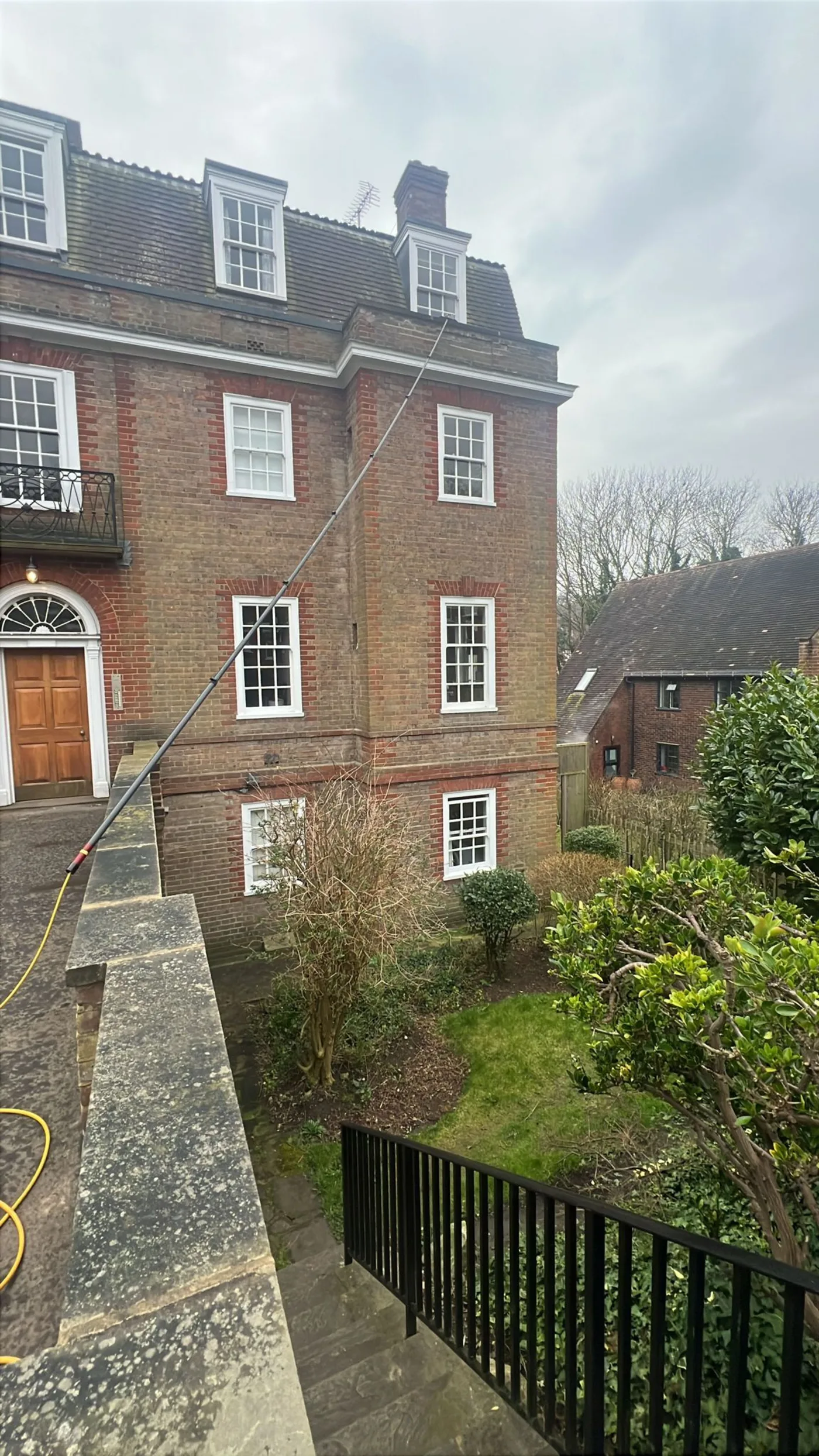 Water-fed pole reaching the upper floors of a large red brick Georgian house